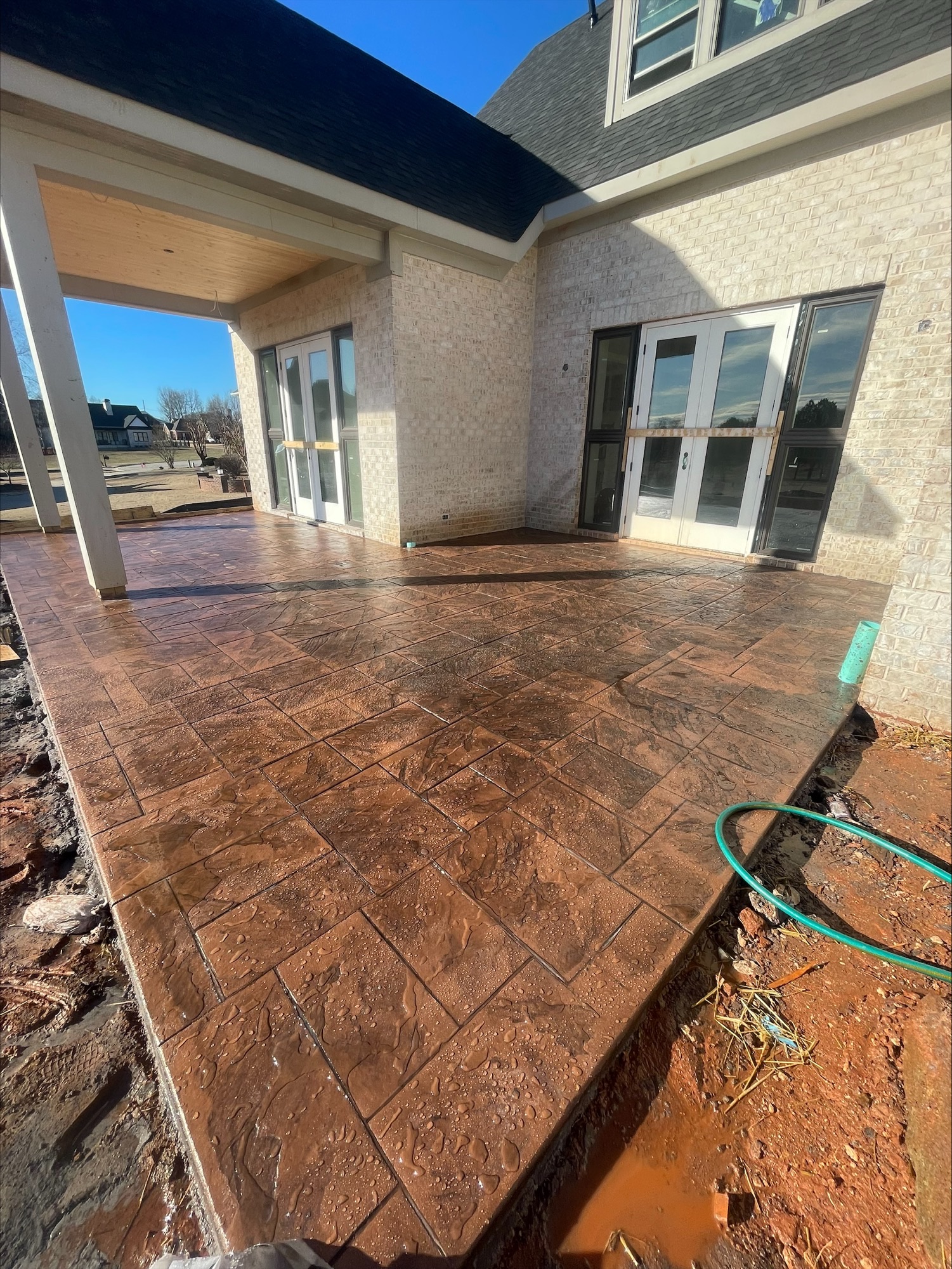 Newly sealed stamped concrete patio at a residential home